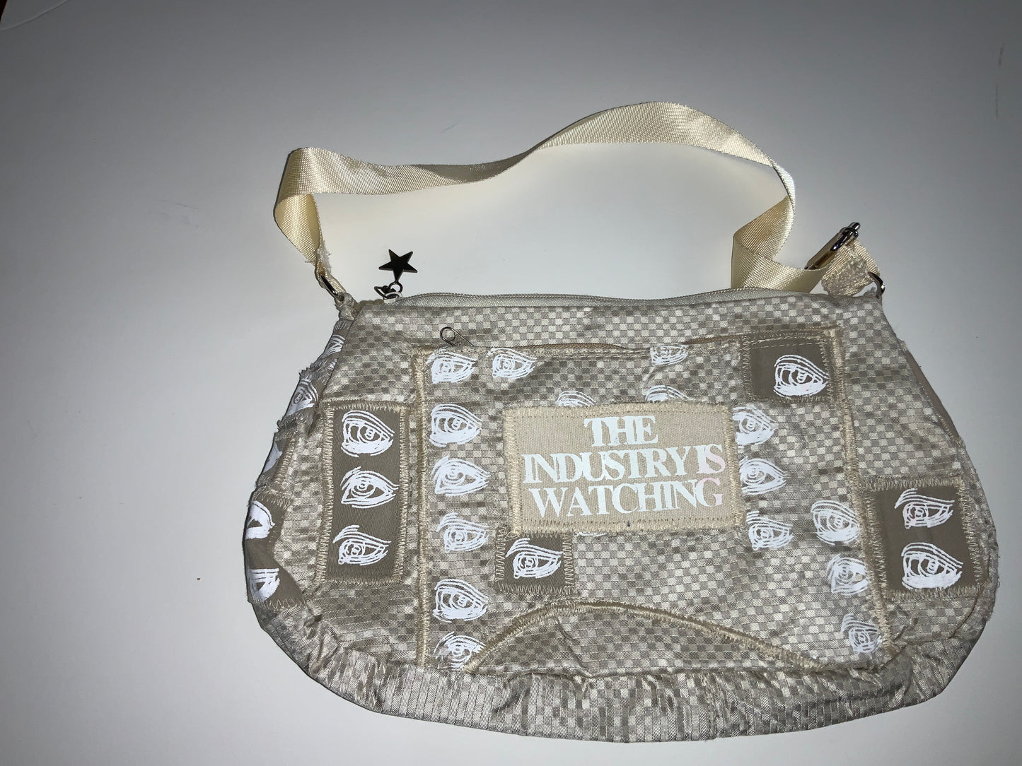 Industry’s watching beige purse